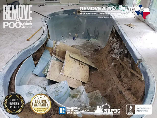 Draining the pool completely to prepare it for the deconstruction phase.